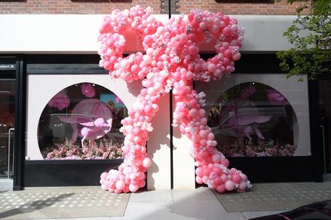 Exterior of PrettyLittleThing, London, showing a giant ribbon made up of pink balloons